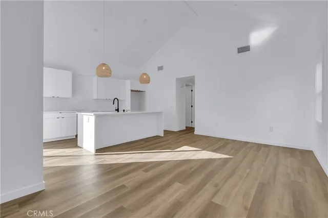 a view of a kitchen with wooden floor and sink