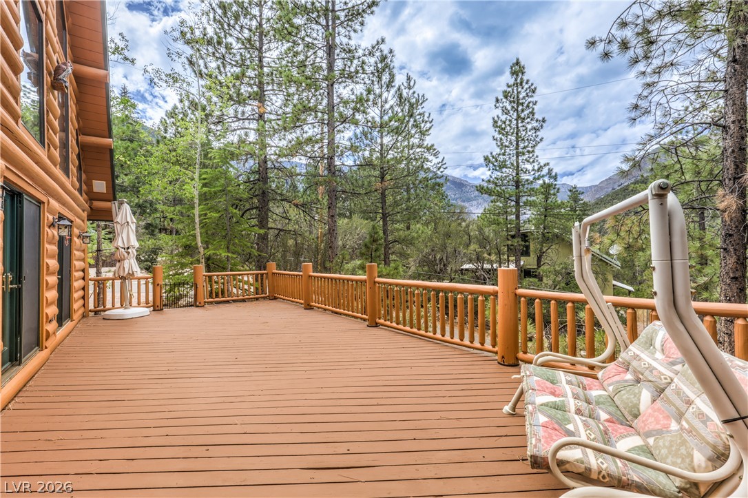 322 Ski Trail Road Mount Charleston, NV 89124 - Photo 40 of 58 An expansive wooden deck overlooks towering pines and majestic mountain vistas.