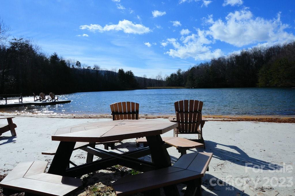 0 Melrose Mountain Road, Unit 513 Tryon, NC 28782 - Photo 5 of 7 a view of a patio with table and chairs with wooden floor and fence