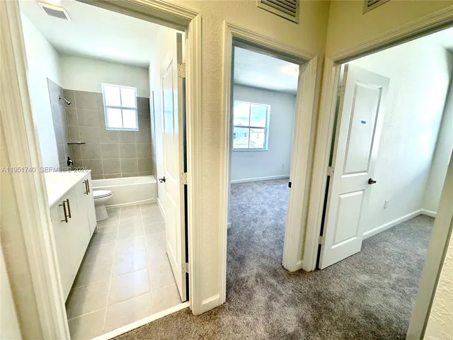 wooden floor with a bathroom