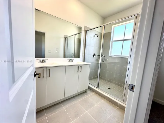 a bathroom with a shower and a sink