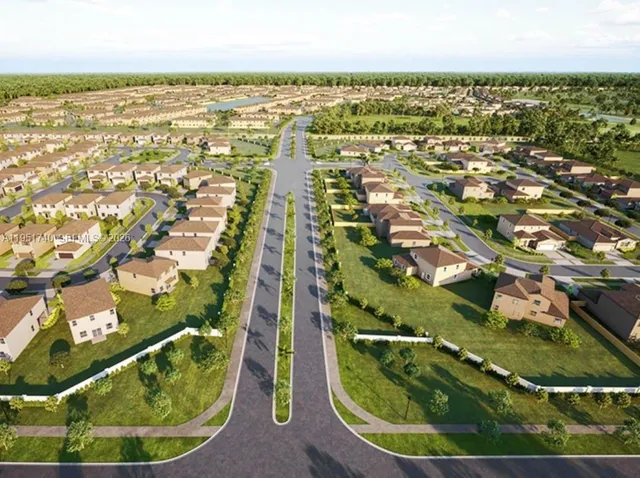 an aerial view of residential houses with outdoor space and trees