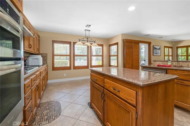 a kitchen with stainless steel appliances granite countertop a stove and a sink