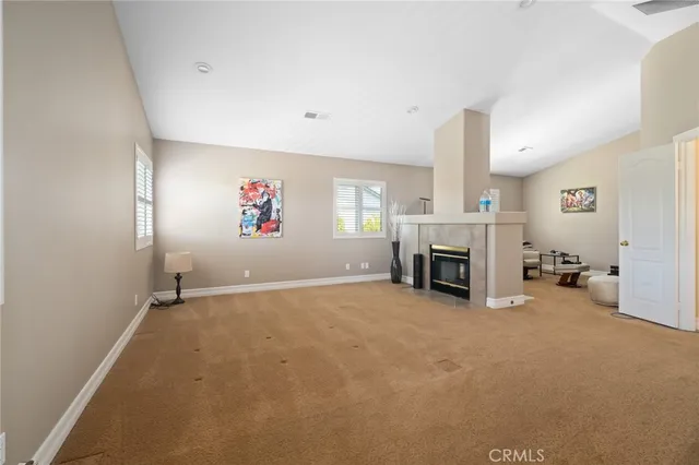 a view of a livingroom with a fireplace and a window
