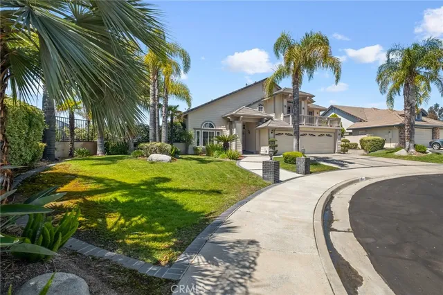 a front view of a house with a garden and patio
