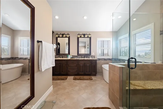a large bathroom with a large tub and sink