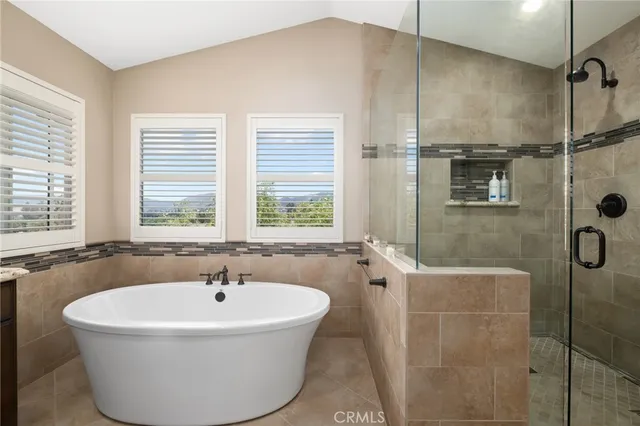 a white bath tub sitting in a bathroom next to a window