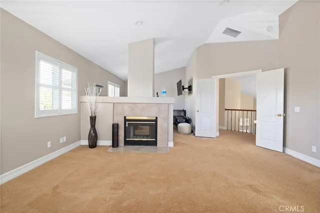 an empty room with windows and a fireplace