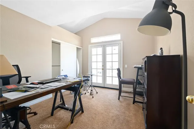 a view of a workspace with furniture and a window