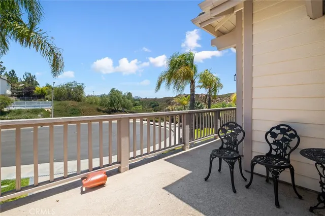 a view of a chair and table in the balcony