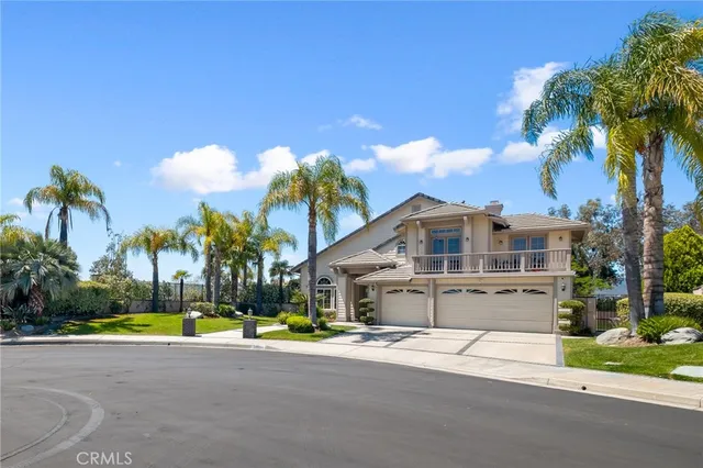 a view of a house with a swimming pool and a yard