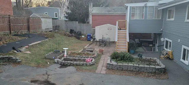 a view of a chairs and table in backyard