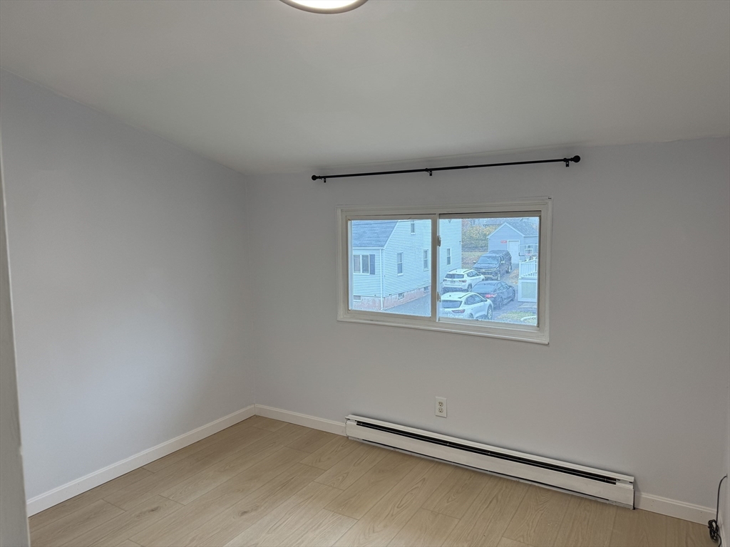 8 Glen Avenue, Unit 2 Melrose, MA 02176 - Photo 4 of 14 an empty room with a window