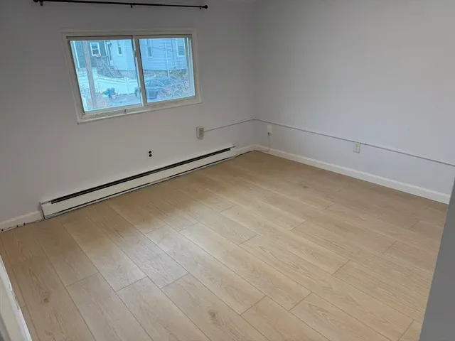 a view of a room with wooden floor