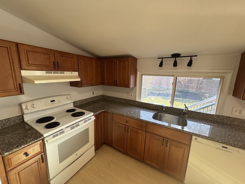 8 Glen Avenue, Unit 2 Melrose, MA 02176 - Photo 7 of 14 a kitchen with granite countertop a sink stove and cabinets
