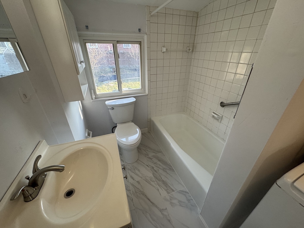 8 Glen Avenue, Unit 2 Melrose, MA 02176 - Photo 10 of 14 a bathroom with a sink and a tub