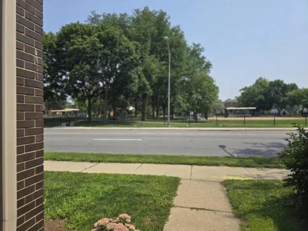 a view of a brick house with a small yard