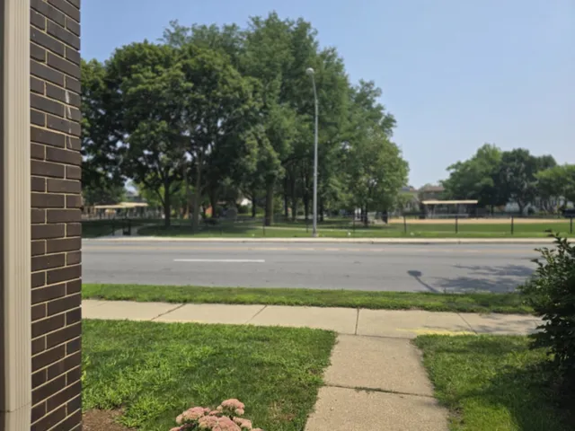 a view of a brick house with a small yard
