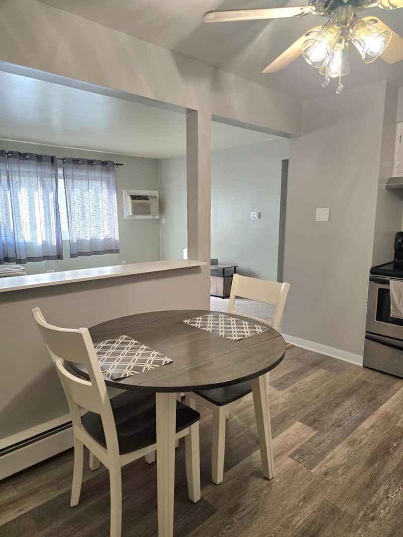 1101 Harlem Avenue, Unit 203 Oak Park, IL 60130 - Photo 3 of 58 a view of a dining room with furniture and wooden floor
