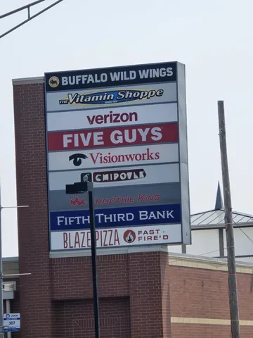 a store with cars parked in front of it