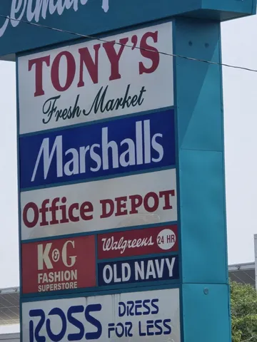 a view of city street with a car parked on the road