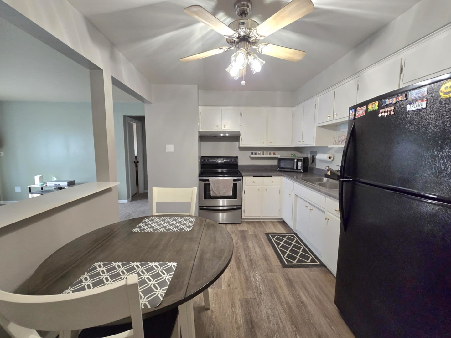 1101 Harlem Avenue, Unit 203 Oak Park, IL 60130 - Photo 5 of 58 a kitchen with granite countertop stainless steel appliances a refrigerator a stove top oven a sink a dining table and chairs