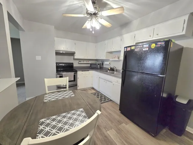 a kitchen with granite countertop a stove and cabinets