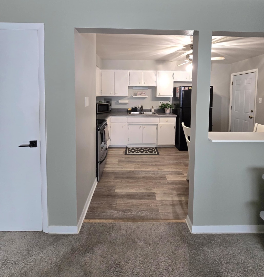 1101 Harlem Avenue, Unit 203 Oak Park, IL 60130 - Photo 8 of 58 a kitchen with white cabinets and stainless steel appliances