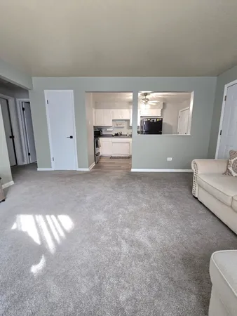 a kitchen with white cabinets and appliances