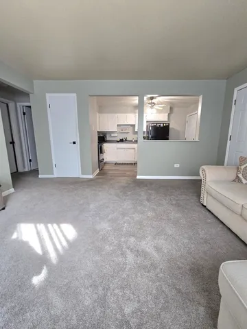 a kitchen with white cabinets and appliances