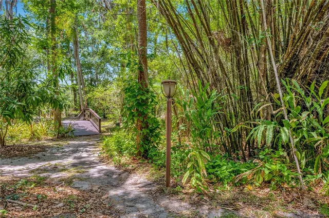 a kitchen with sink refrigerator and chandelier