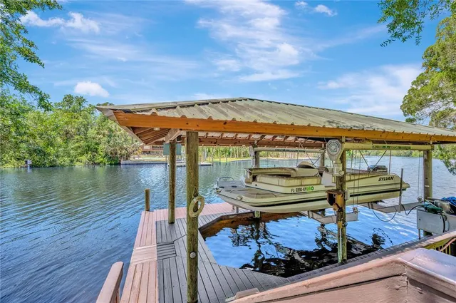a view of a balcony with chairs and wooden floor