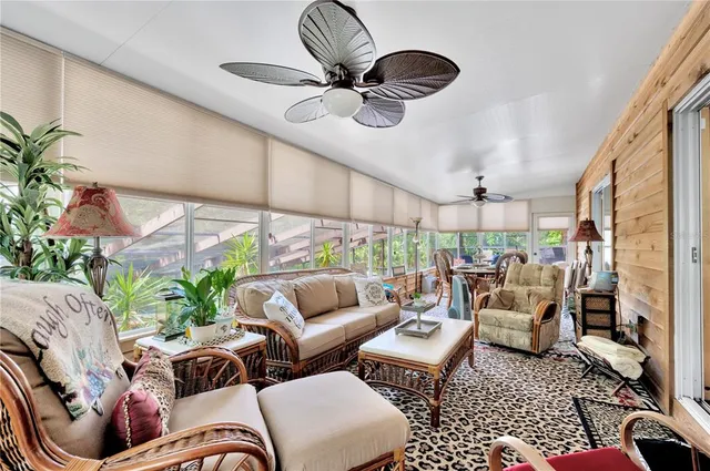 a living room with furniture a rug and a chandelier