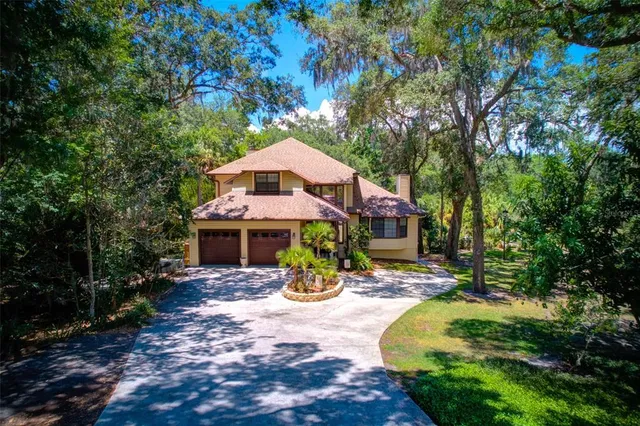 a view of a house with yard and sitting area