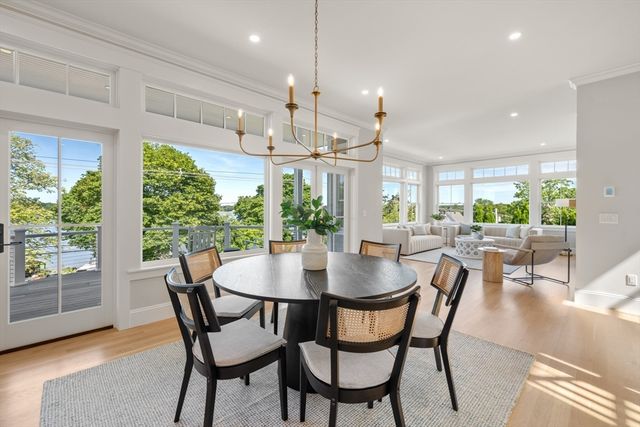 a dining room with furniture a chandelier and wooden floor