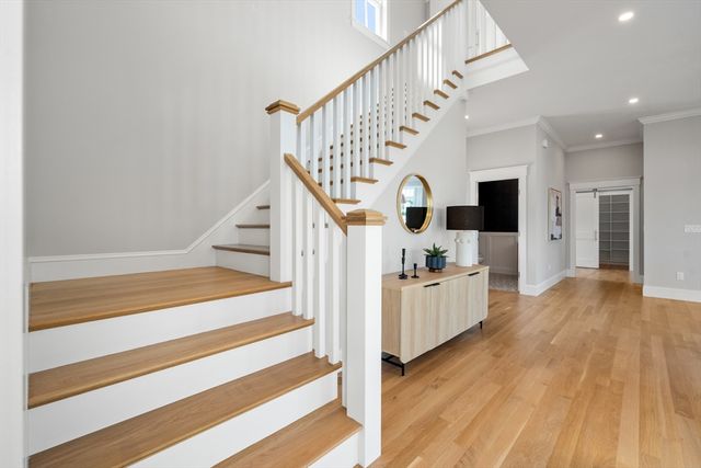 a view of entryway and hall with wooden floor