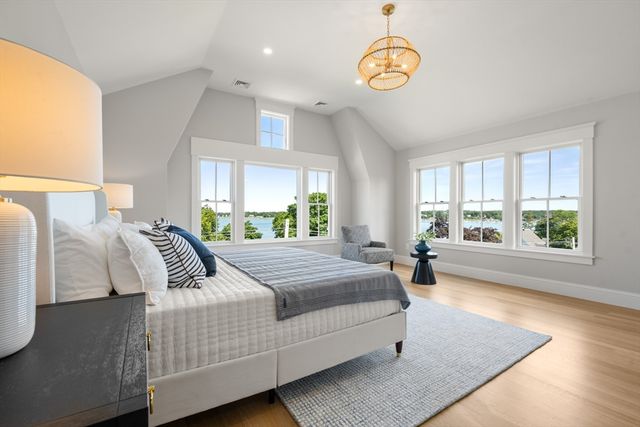 a bedroom with a bed and a large window