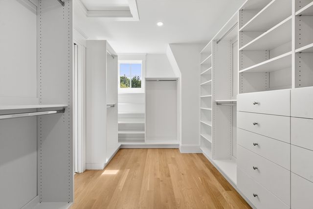 a view of walk in closet with empty racks