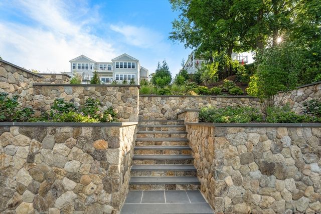 a front view of a house with garden