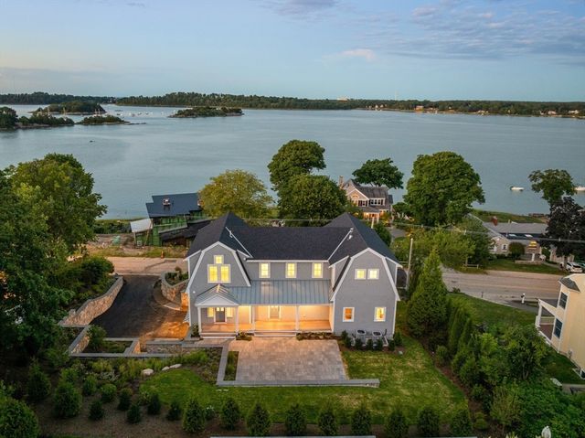 an aerial view of a house with a lake view and a mountain view