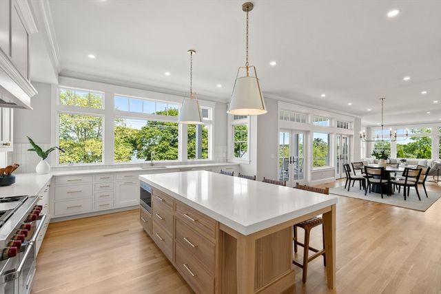a large kitchen with kitchen island a large window