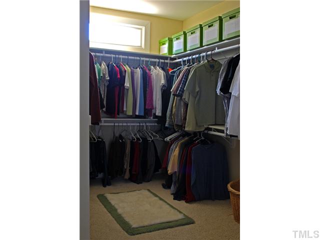 1204 Red Brick Road Garner, NC 27529 - Photo 6 of 12 a view of walk in closet with clothes and shoes