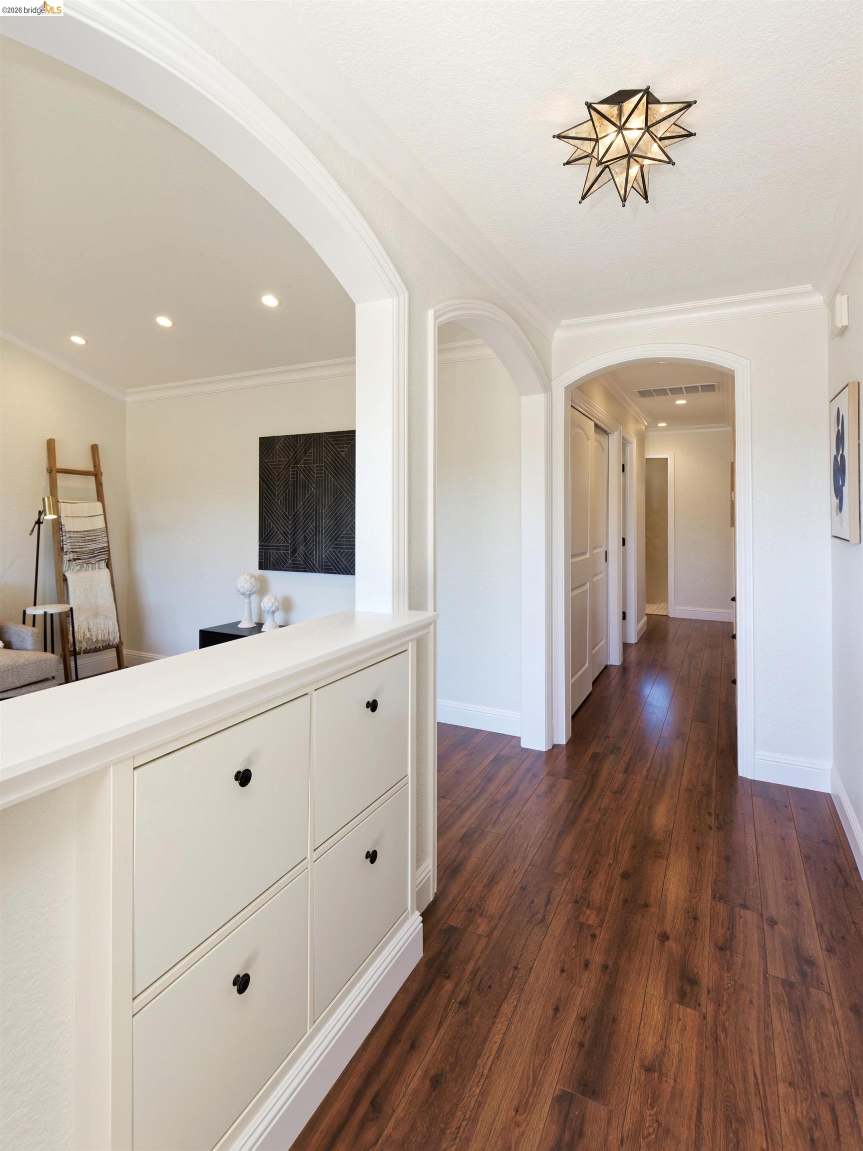 983 Seascape Circle Rodeo, CA 94572 - Photo 11 of 45 Hall featuring arched walkways, dark wood finished floors, and ornamental molding