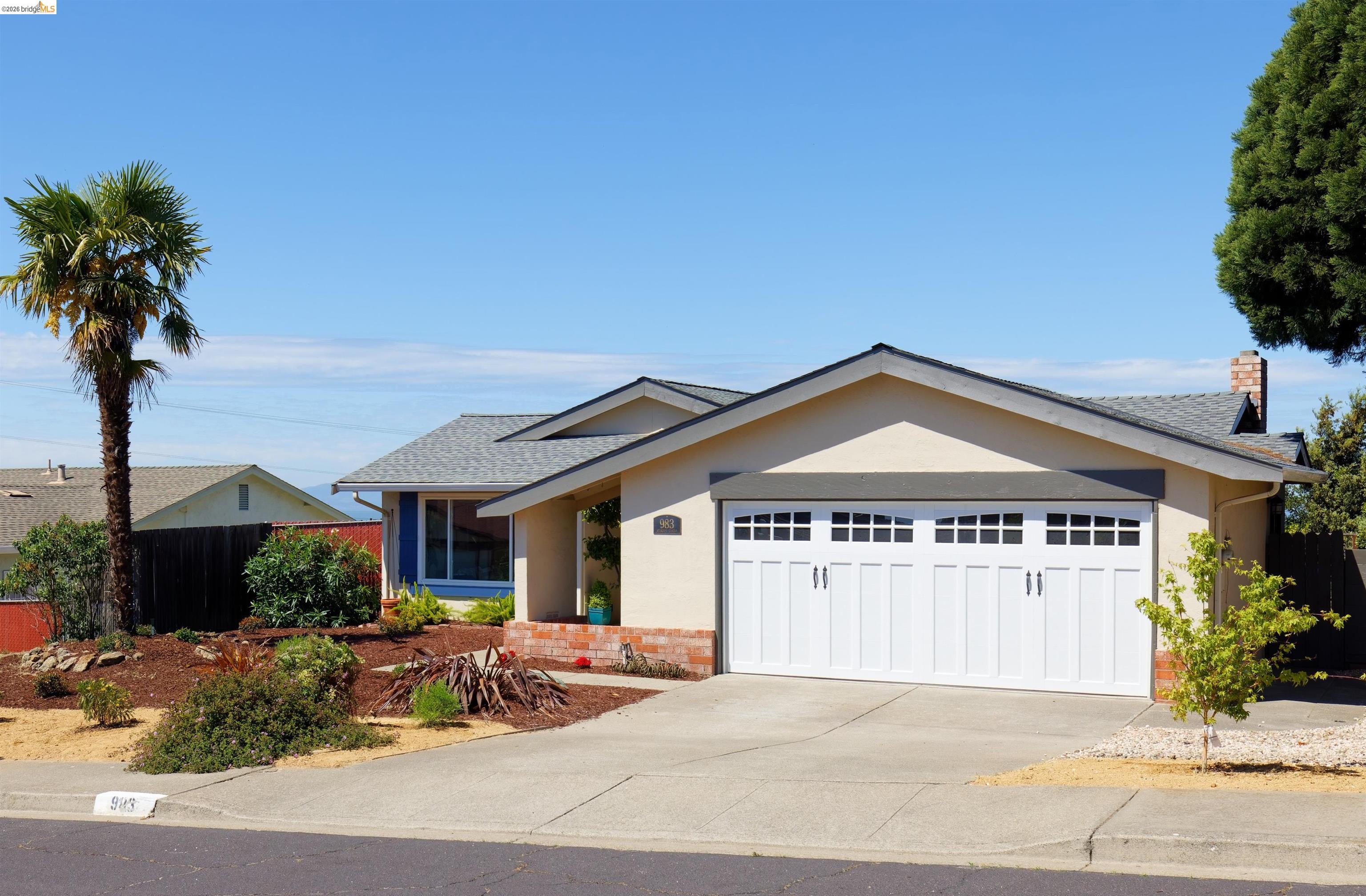 983 Seascape Circle Rodeo, CA 94572 - Photo 2 of 45 View of front facade with a garage, stucco siding, driveway, and a shingled roof