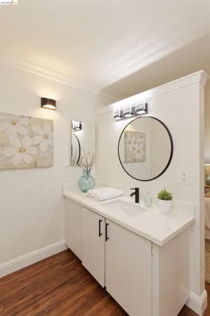 a bathroom with a sink mirror and vanity