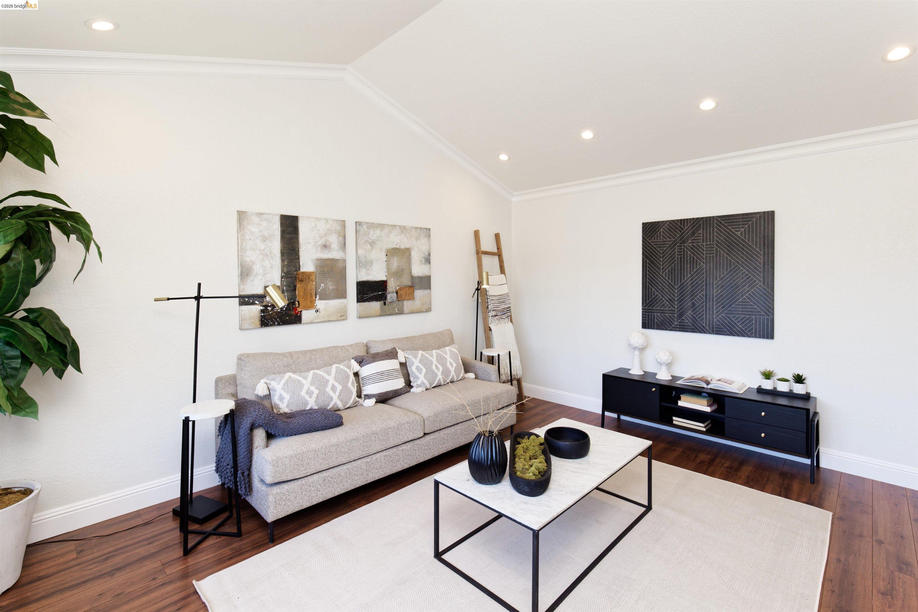 983 Seascape Circle Rodeo, CA 94572 - Photo 10 of 45 Living area featuring ornamental molding, dark wood-type flooring, vaulted ceiling, and recessed lighting