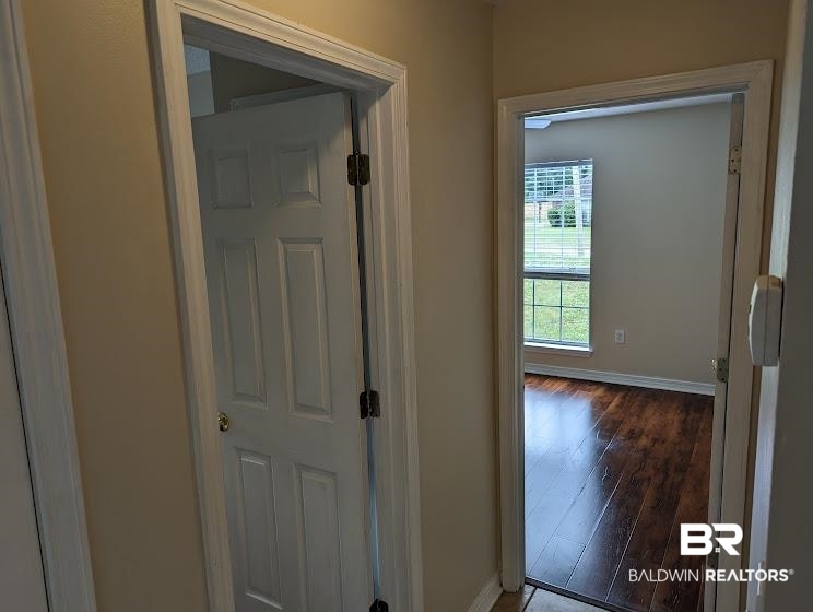 12971 Labradors Run Foley, AL 36535 - Photo 8 of 23 Interior room featuring wood-finish flooring, a window with horizontal blinds, and neutral wall tones