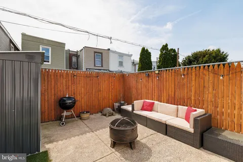 a backyard with a couch and potted plants