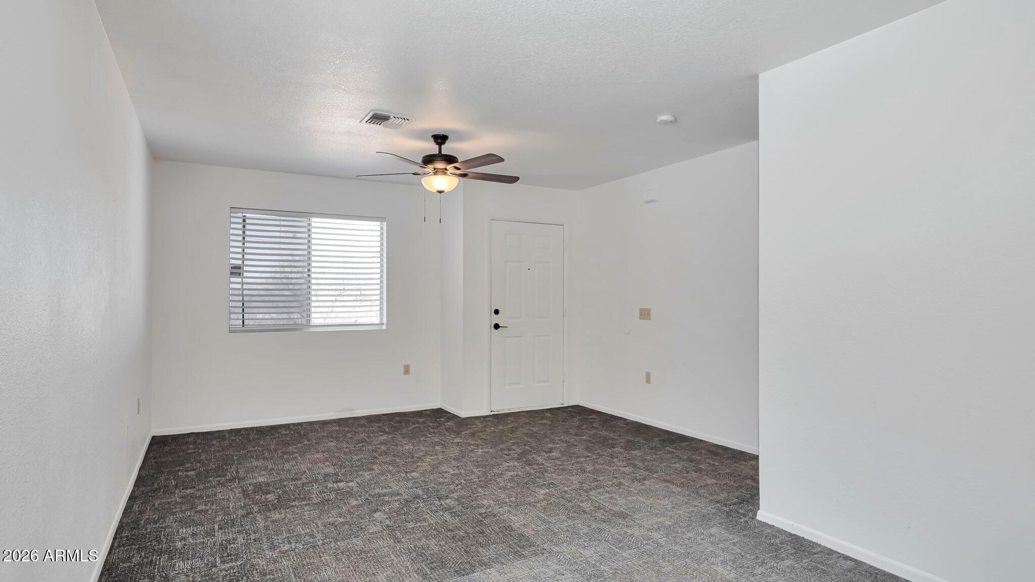 4125 North Pima Way Rimrock, AZ 86335 - Photo 4 of 14 wooden floor in an empty room with a window
