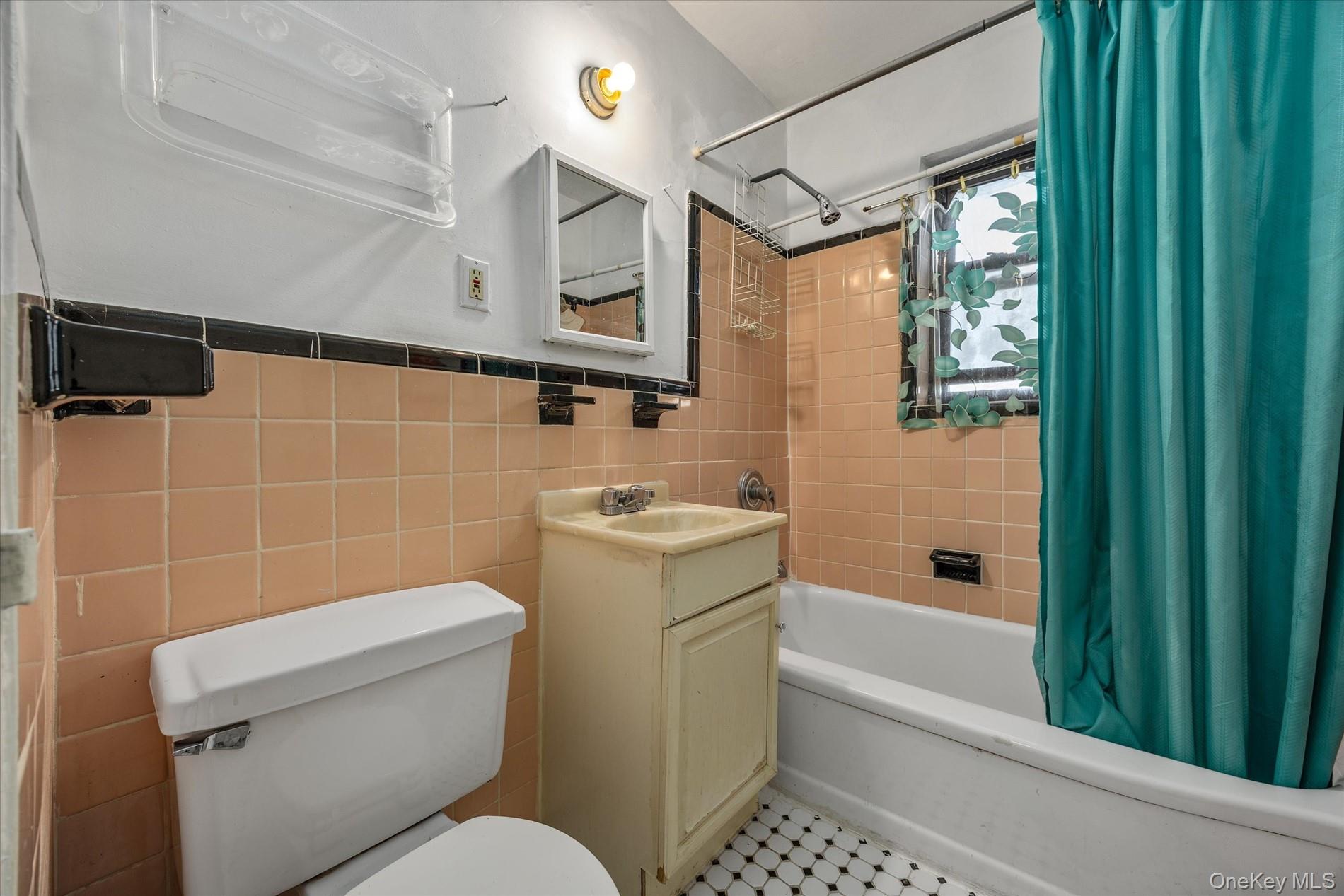 52-35 39th Road, Unit 2C Queens, NY 11377 - Photo 10 of 10 Bathroom with shower / bath combo, vanity, and tile walls